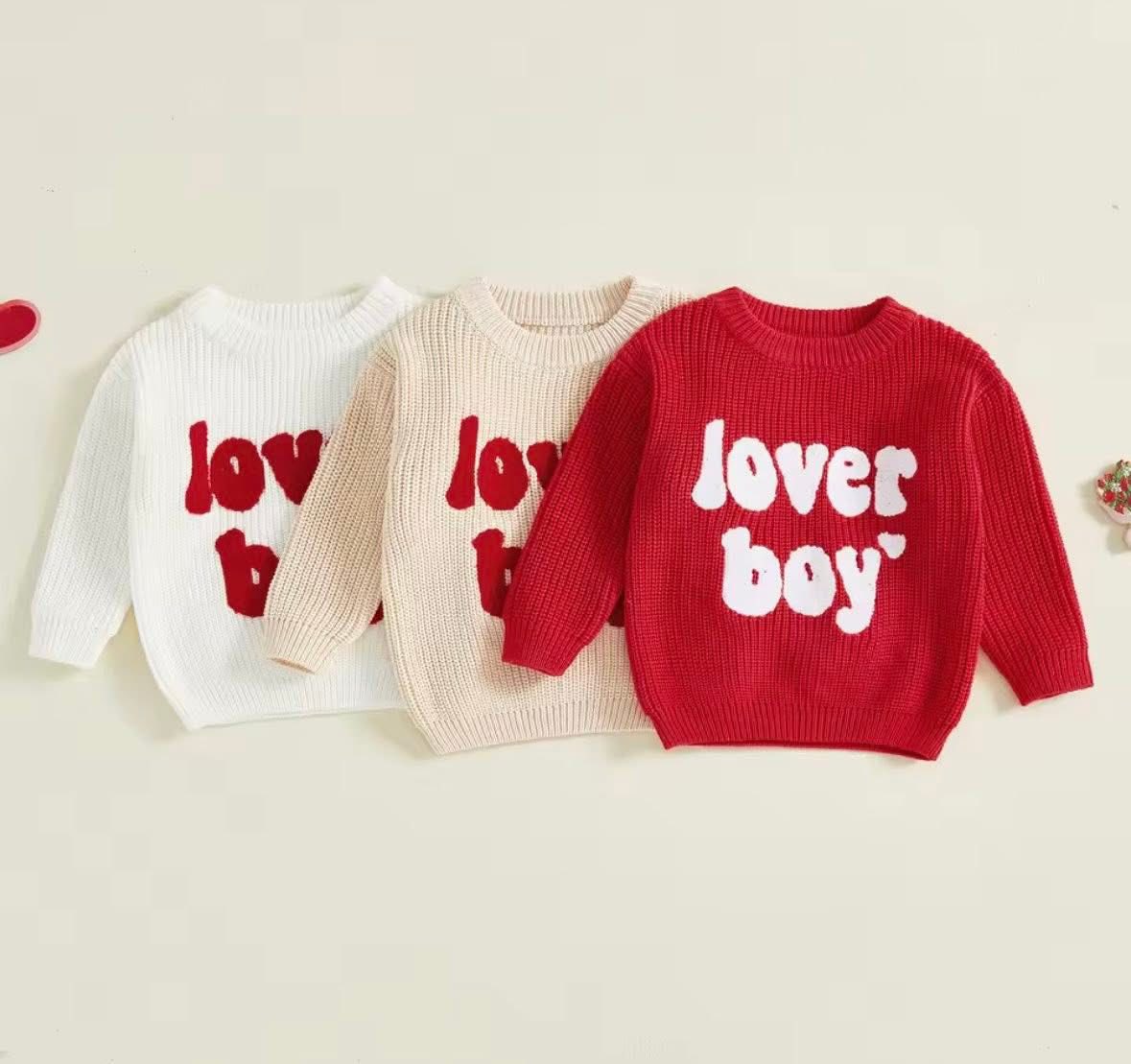 Three children's sweaters with 'love' and 'lover boy' text on a light background