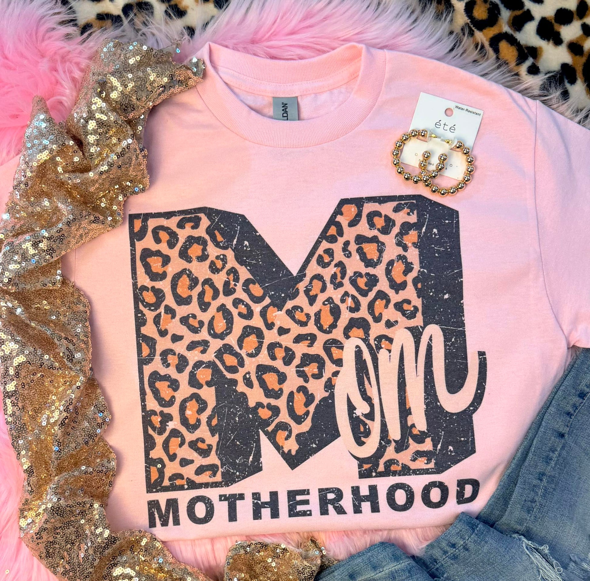 Baby pink Gildan dry blend tee with large leopard-print M and pink MOM script, MOTHERHOOD text.