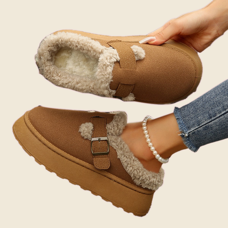 Brown Wagon Fleece Shoes worn on a cream background